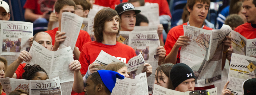 Communications students reading the student newspaper The Shield