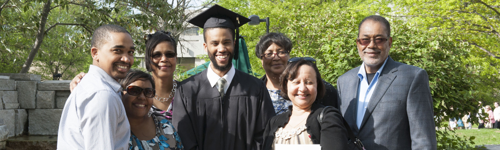 Multicultural center graduate with family