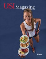 female athlete holding three plates of food
