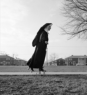 Photo of nun on sidewalk, skating