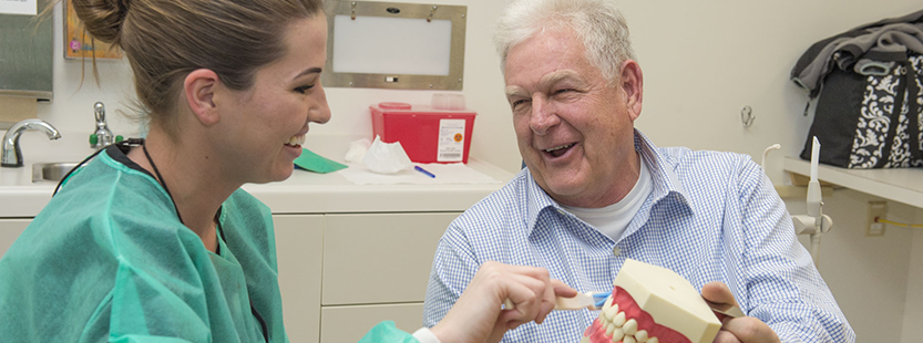 Retiree at a dental appointment with a USI student