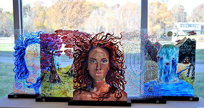 Paintings on flexiglass representing a figure in various abstract forms