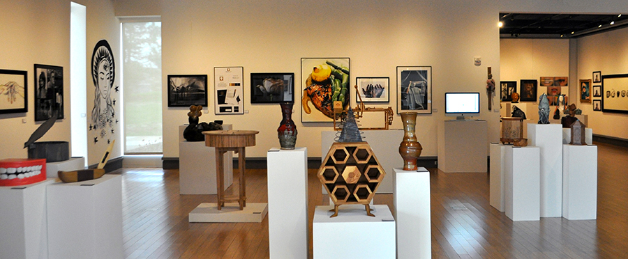 View of art show exhibit space with various pieces on display