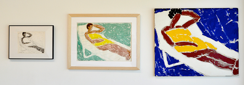 Three pieces: first a framed ink sketch, second a small framed painting, then a larger painting of a figure laying in yellow on a white lounge and a blue background