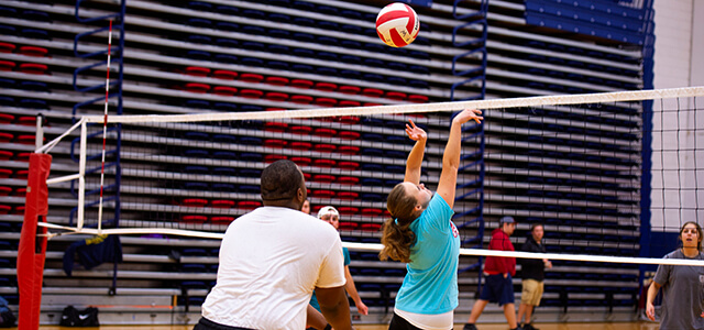 coed students playing volleyball
