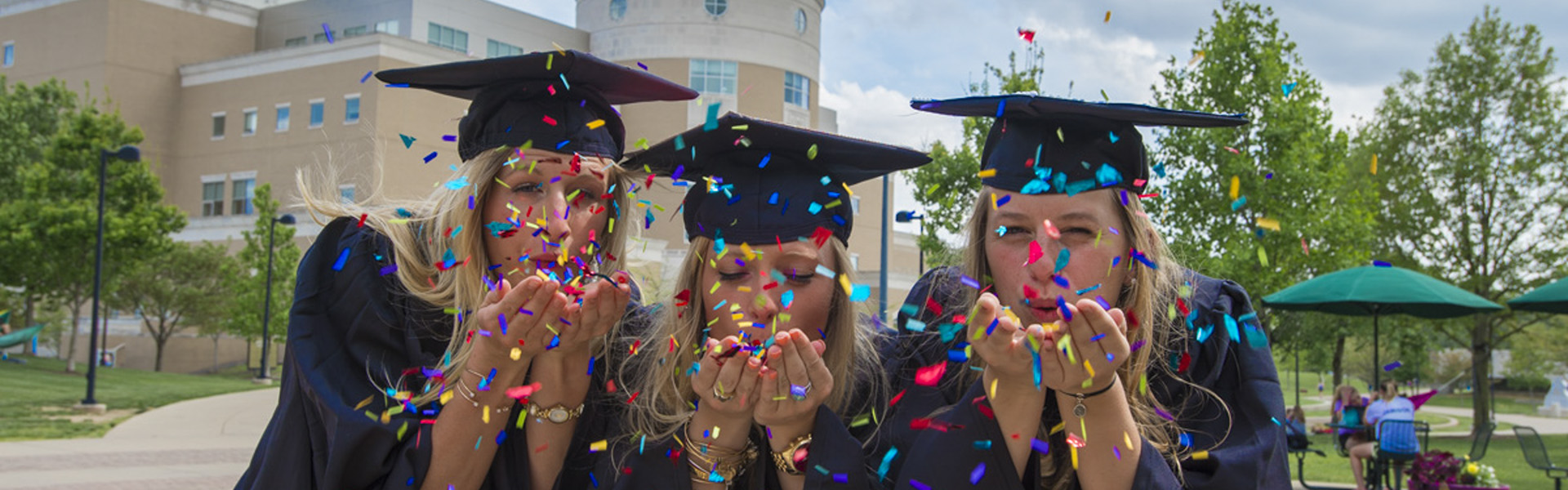 USI graduates  blowing confetti