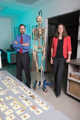 Dr. Michael Strezewski and Dr. Susan Helfrich posing with skeleton