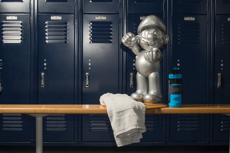 Mario statueon a bench in a locker room
