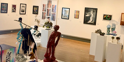 Shot of gallery showing paintings, drawings, ceramics, sculpture, photography