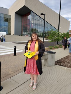 Christy Morley outside Screaming Eagles Arena on commencement day