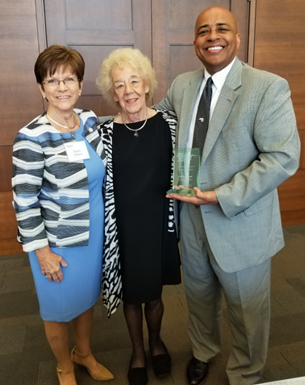 Neal Franklin being presented with the Suzanne A. Nicholson Award. Pictured with Neal are Karen Walker, Chair of the USI Foundation Board of Directors and USI President Dr. Ronald S. Rochon.
