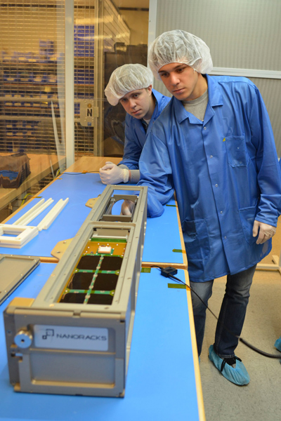 Students working on satellite
