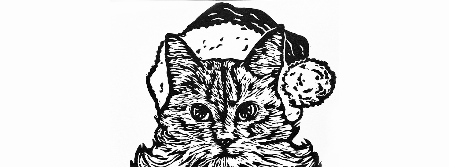 A cat with a Santa hat made from a linoleum print