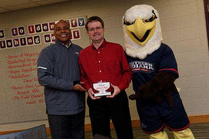 Jeff Sickman (center) poses with President Rochon and Archie after being surprised with USI's third annual Screagle Pride Award