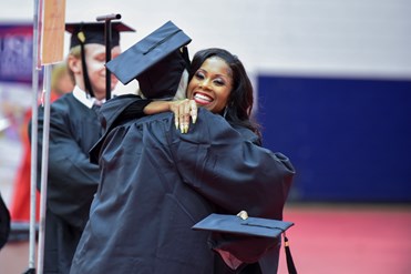 Tiffany Coles gives a hug at USI's fall 2019 Commencement
