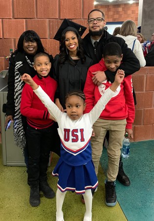 Tiffany Coles poses with her family after fall 2019 Commencement