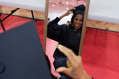 Tiffany Coles adjusts her cap before fall 2019 Commencement