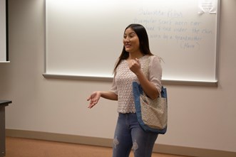 A student shows the purse she created during Lisa Beutler Jones's Honors Seminar