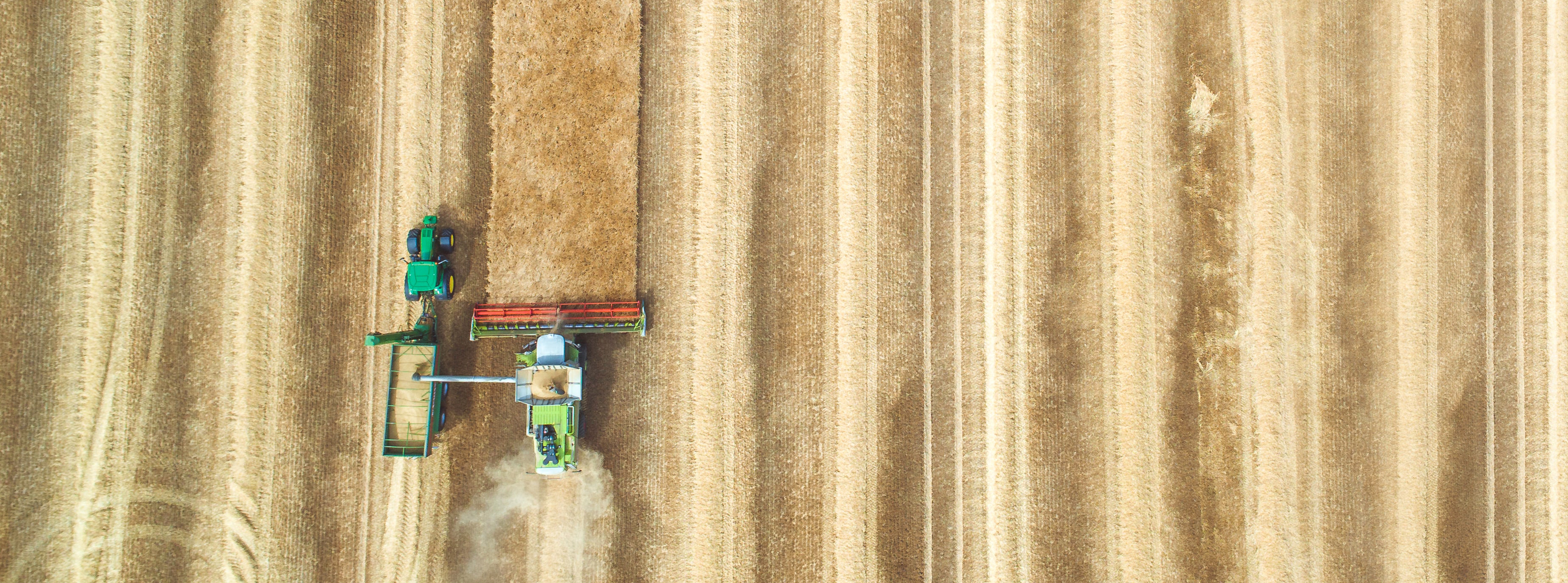 aerial image of a tractor harvesting a field