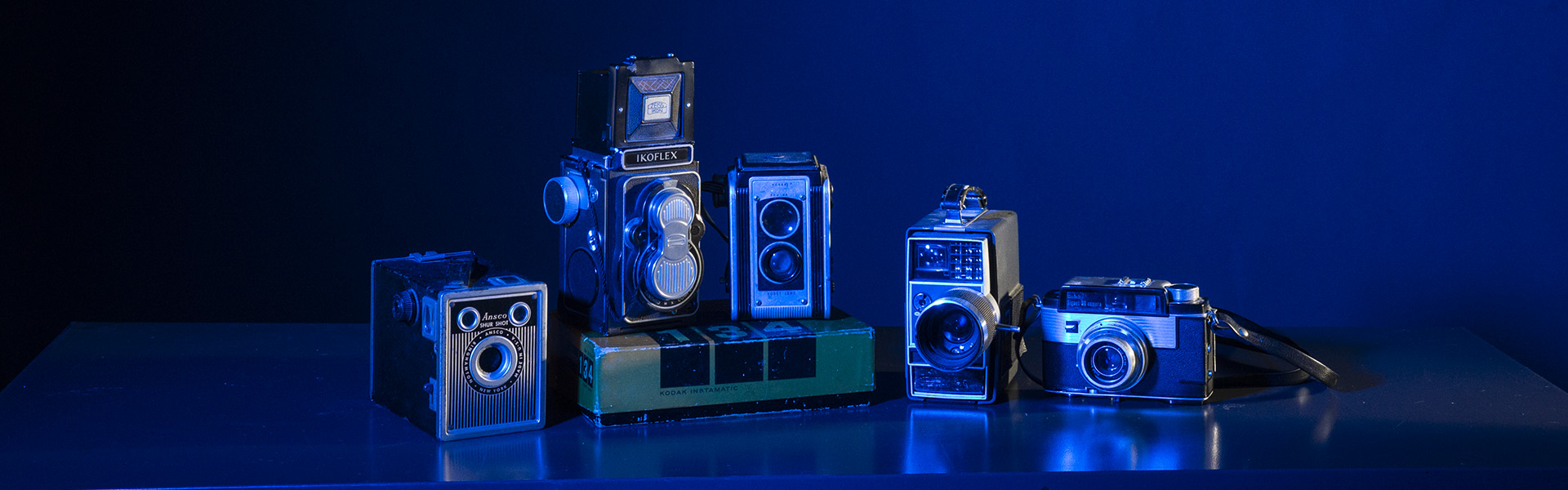 vintage cameras lit with blue gels in studio