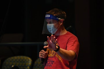 Eric Altheide directs rehearsal of Songs for a New World wearing a mask and face shield