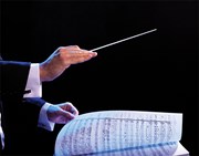 conductor's hand and sheet music